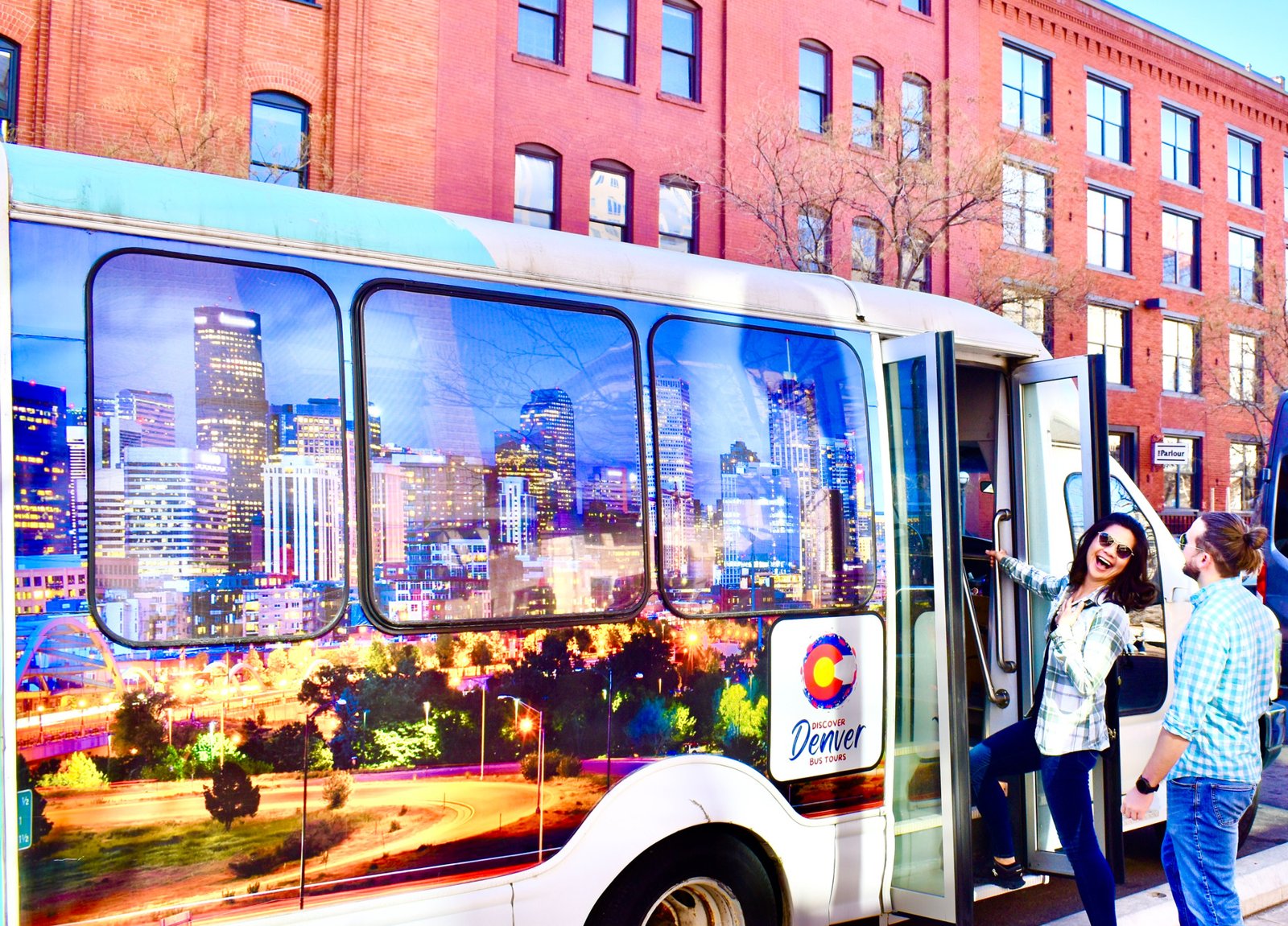 A haunted bus tour passing historic mansions in Denver's Capitol Hill neighborhood at night