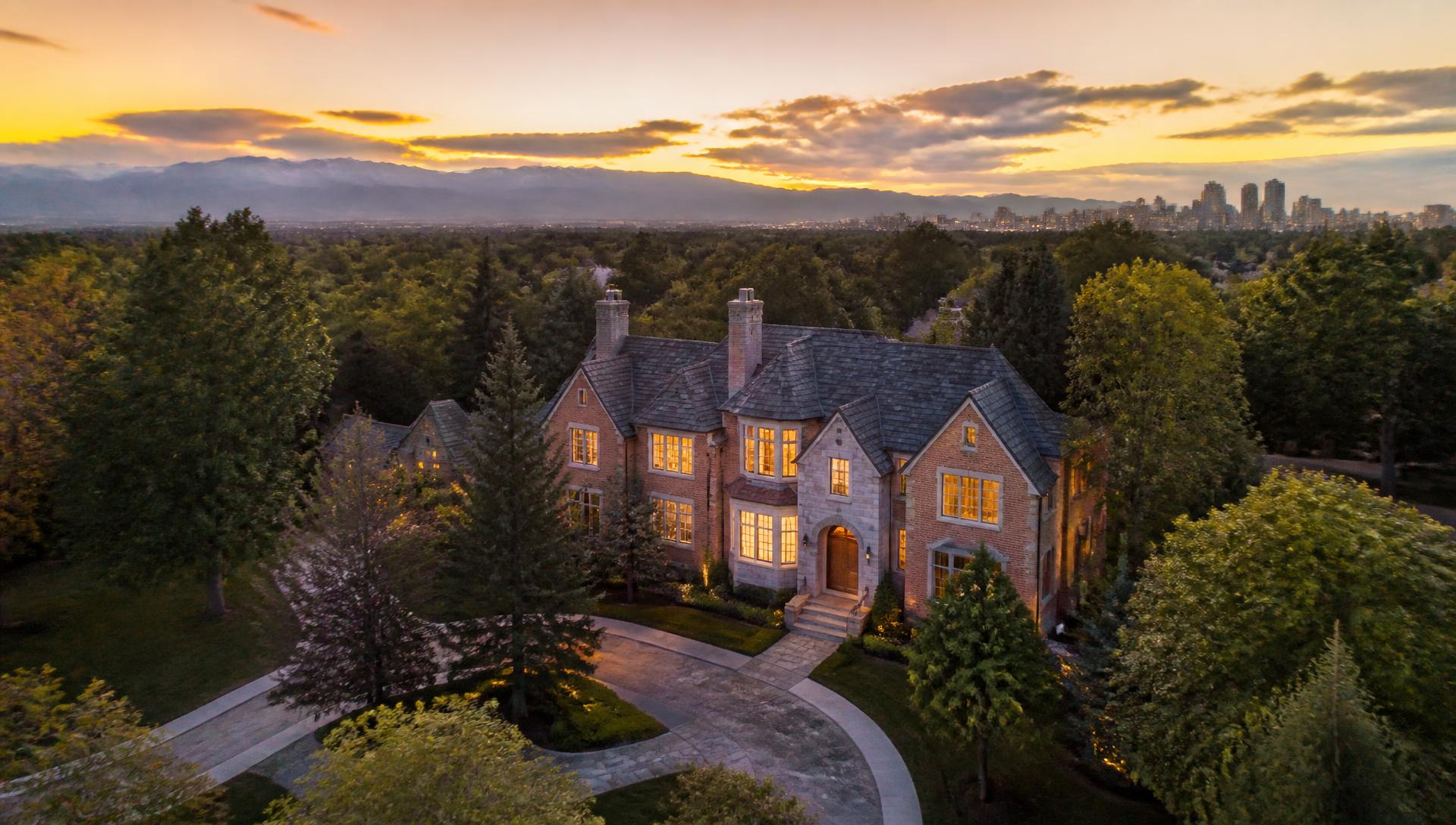 Aerial view of a distinguished brick estate at sunset